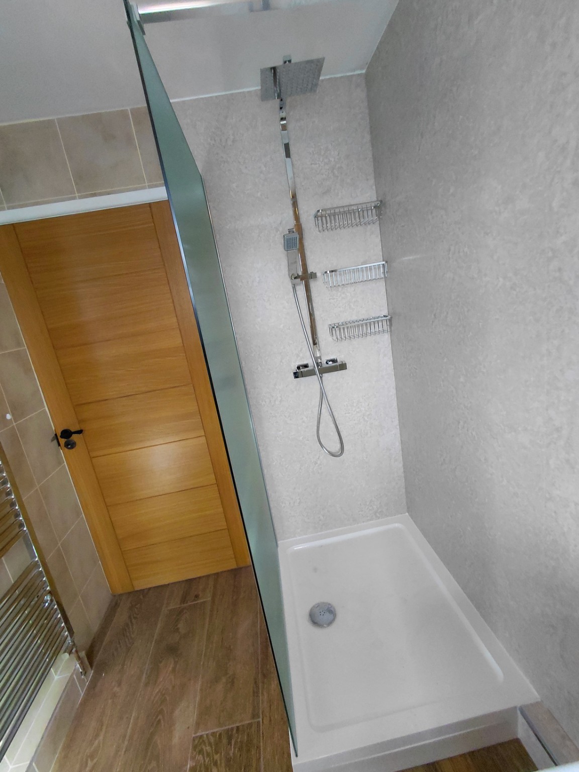 Walk-in shower with new tray, mixer and wall panels fitted by Flowing Solutions